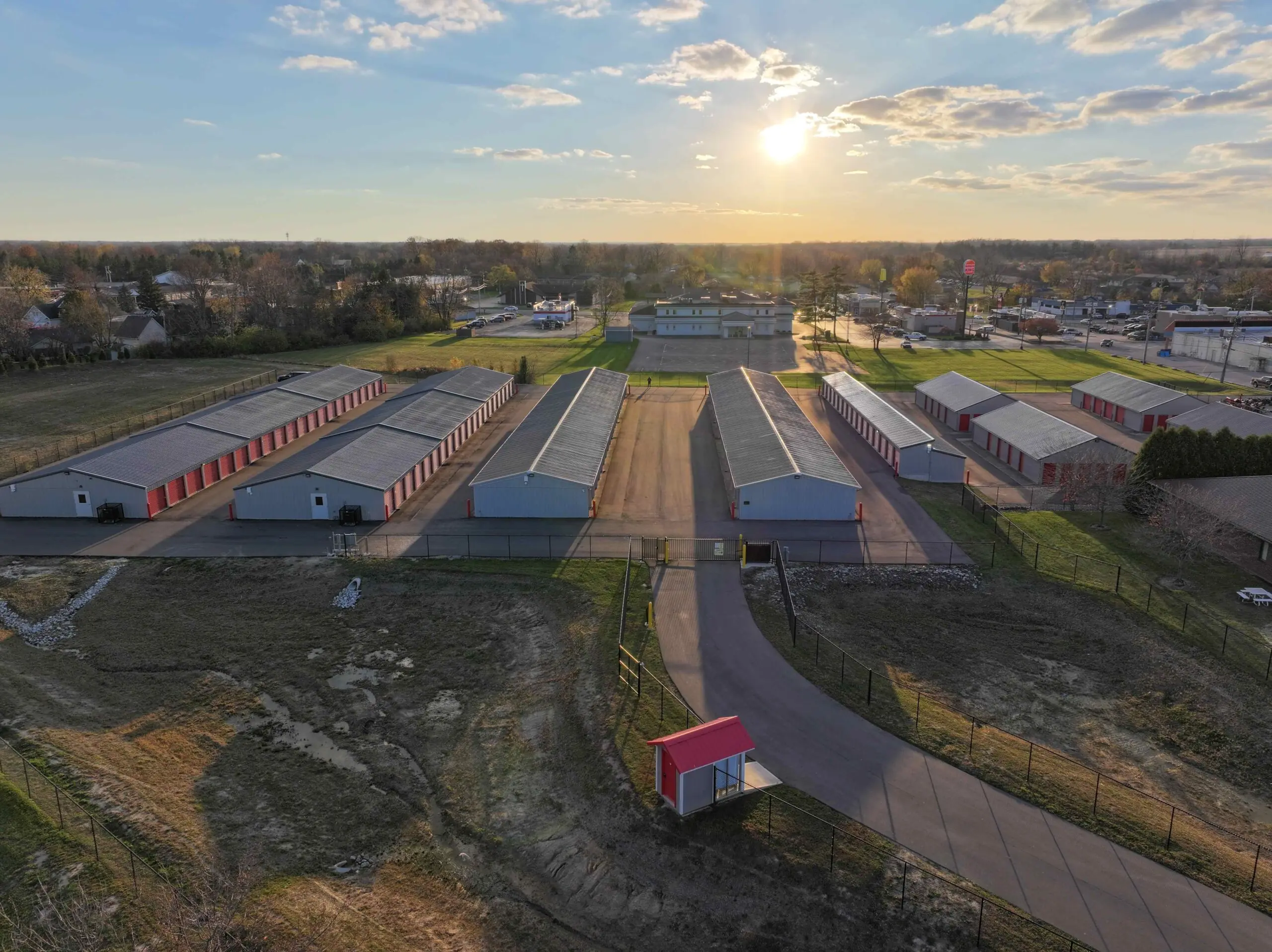 Aerial view of a Wabash self-storage facility featuring multiple rows of red and gray storage units in a clean, secure area. The location provides easy access for loading and unloading, offering reliable storage solutions.